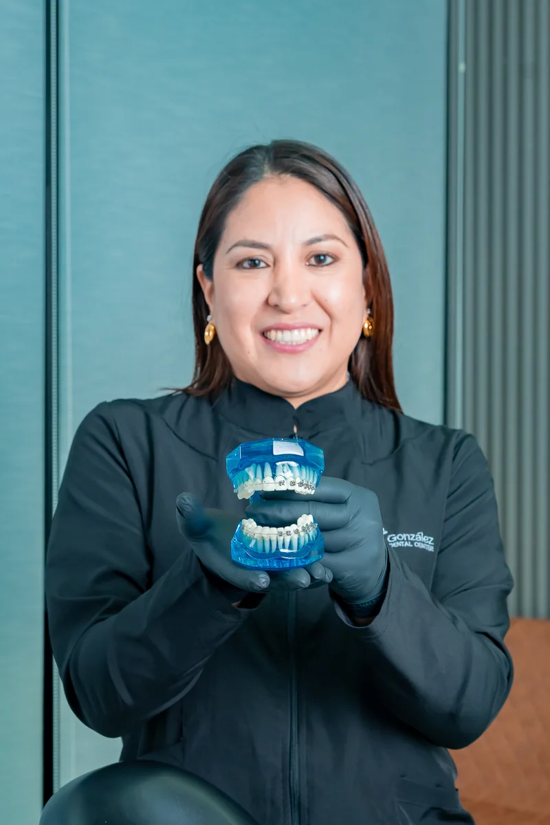 Profesional de González Dental Center presentando un modelo de ortodoncia